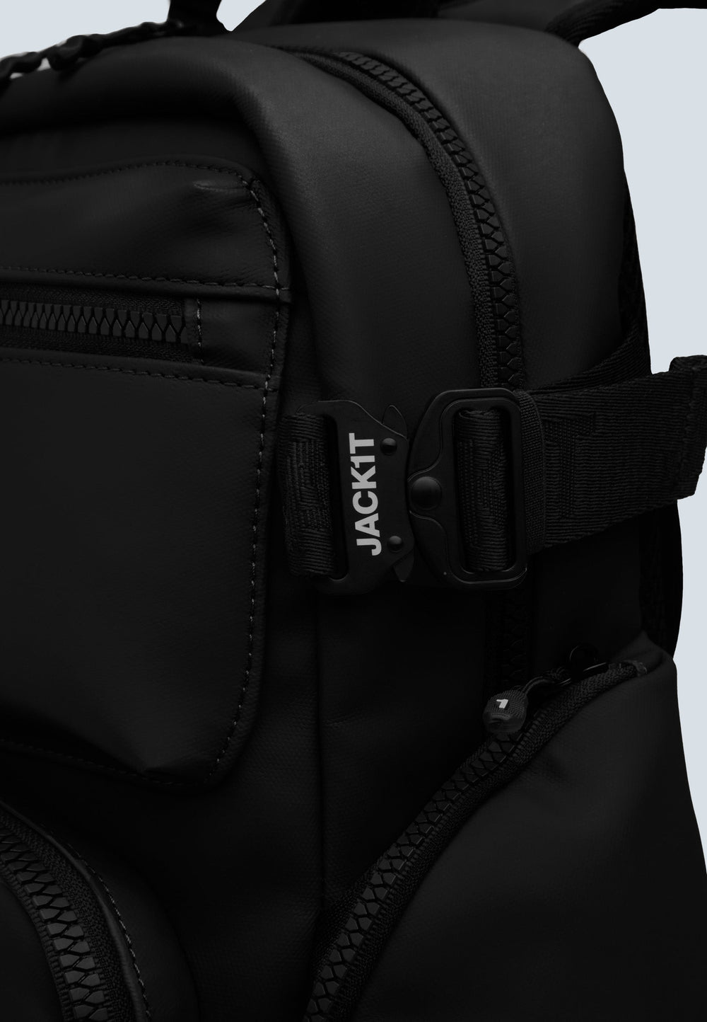 Close-up view of JACK1T's black water resistant backpack showcasing the buckle and pocket details.