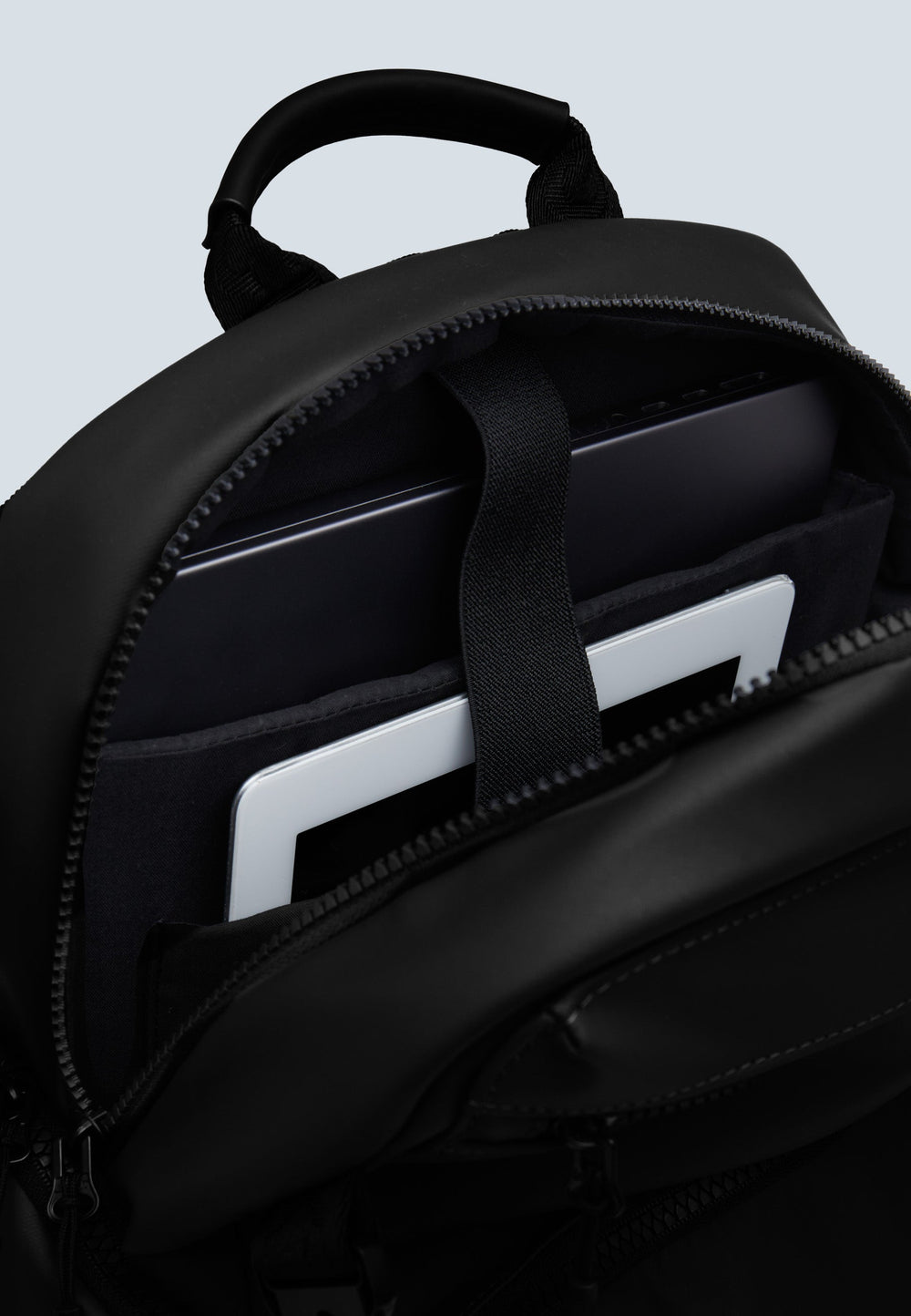 Interior view of JACK1T's black water resistant backpack showcasing padded laptop compartment.