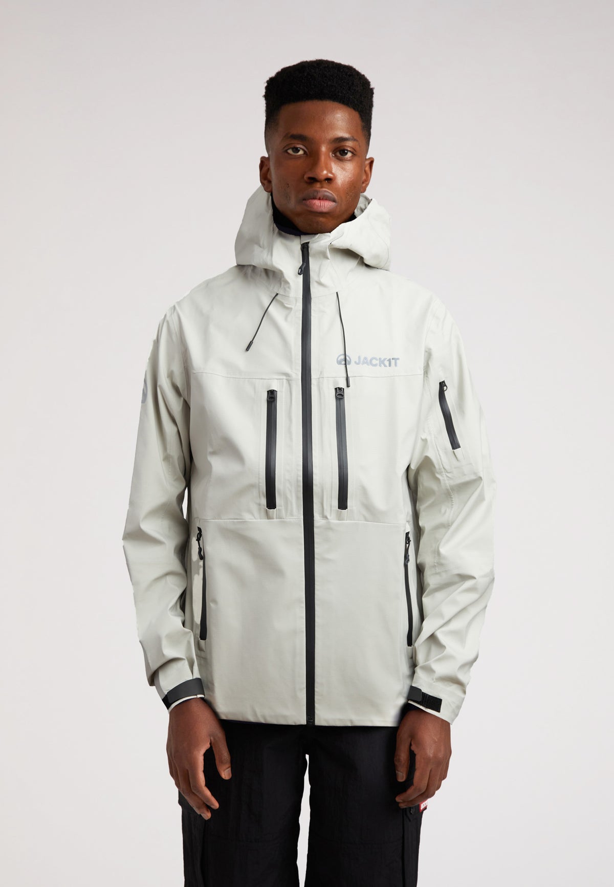Stone mens lithium waterproof jacket worn by model in light gray color, showcasing advanced waterproof design.