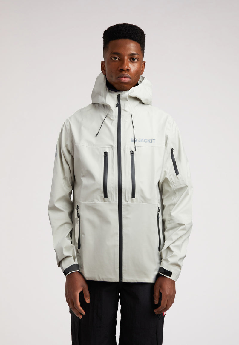 Stone mens lithium waterproof jacket worn by model in light gray color, showcasing advanced waterproof design.