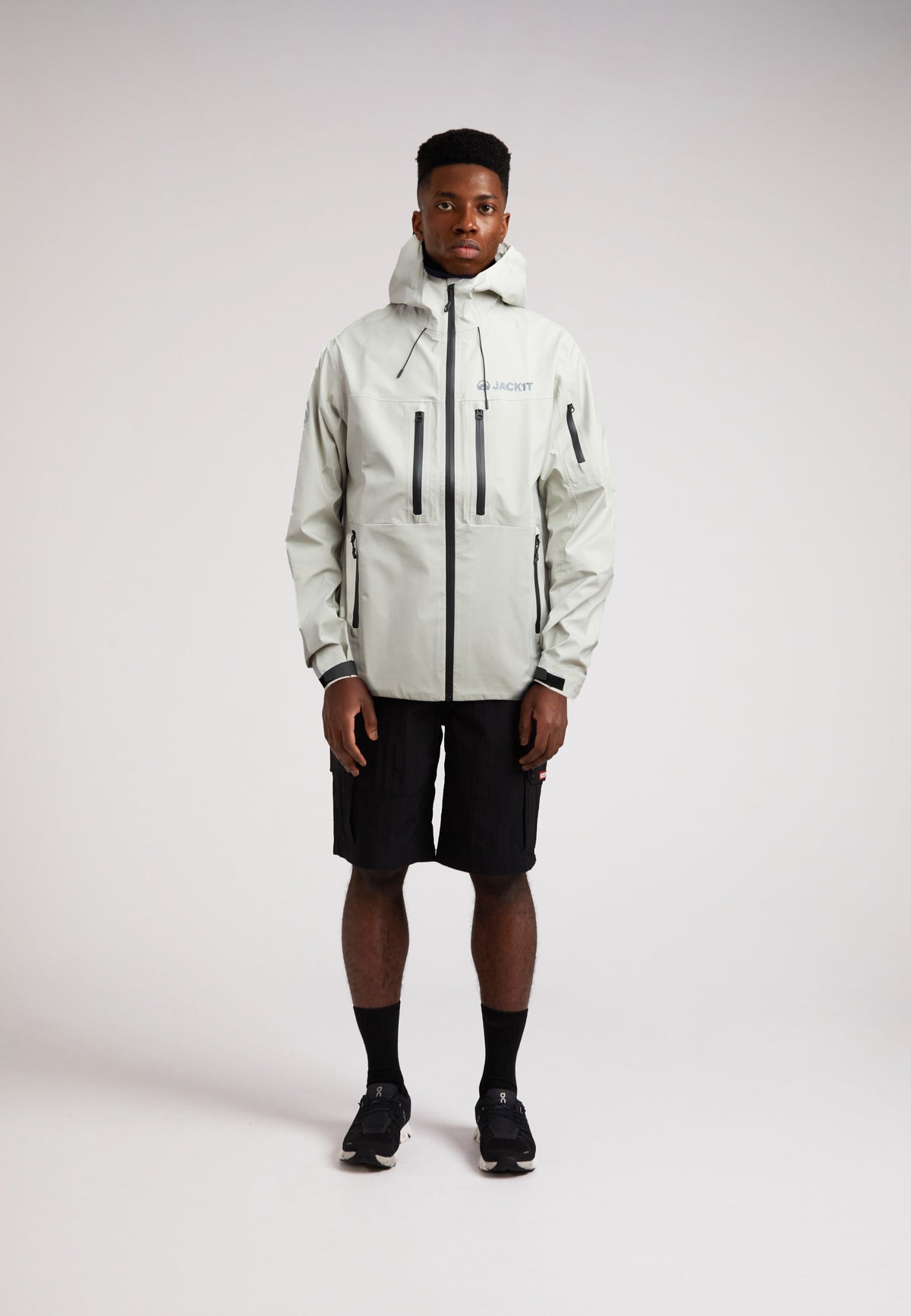 Stone mens lithium waterproof jacket worn by model, showcasing its sleek design and functionality.