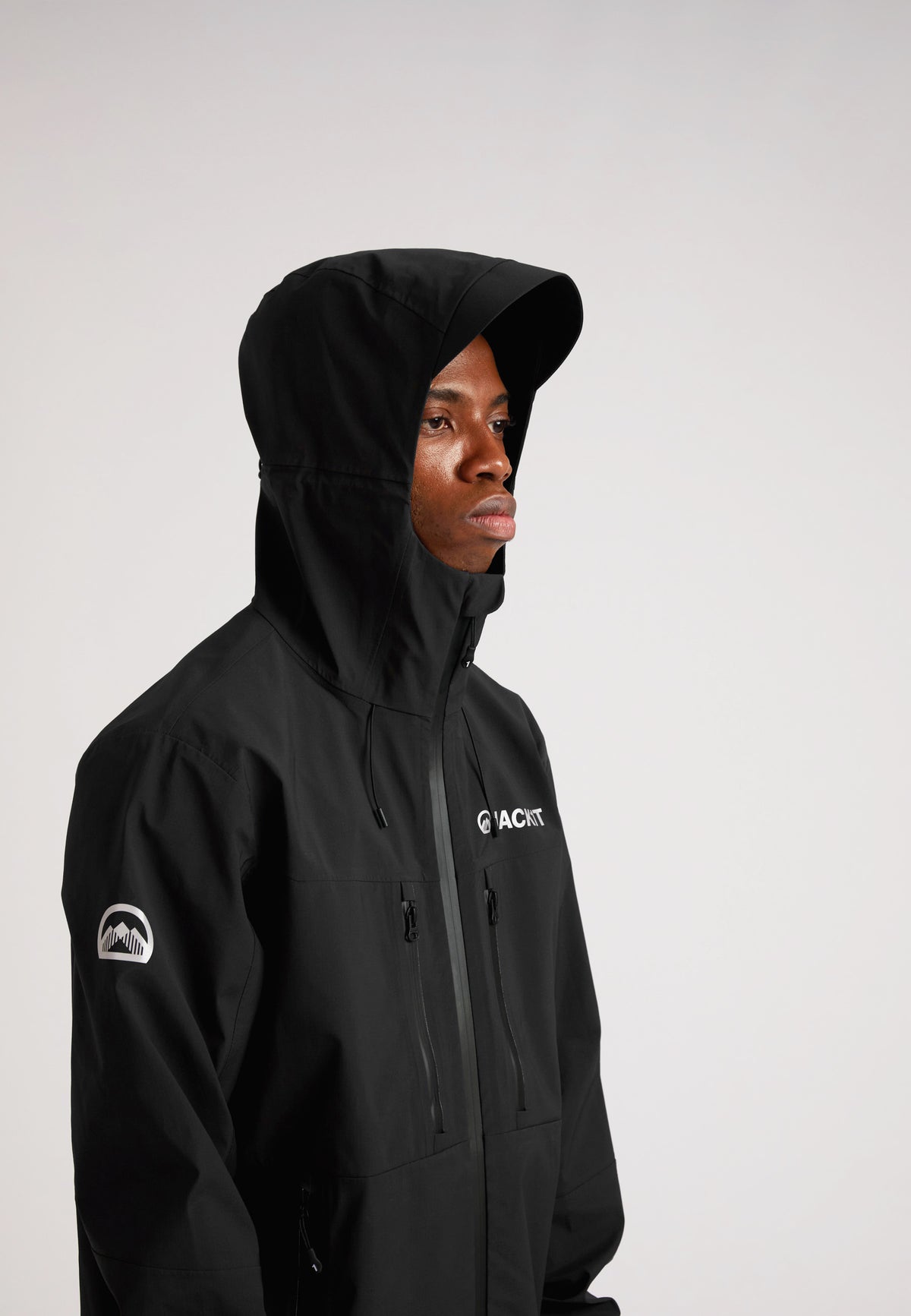 Black mens Lithium waterproof jacket worn by model showcasing its waterproof features and hood design.