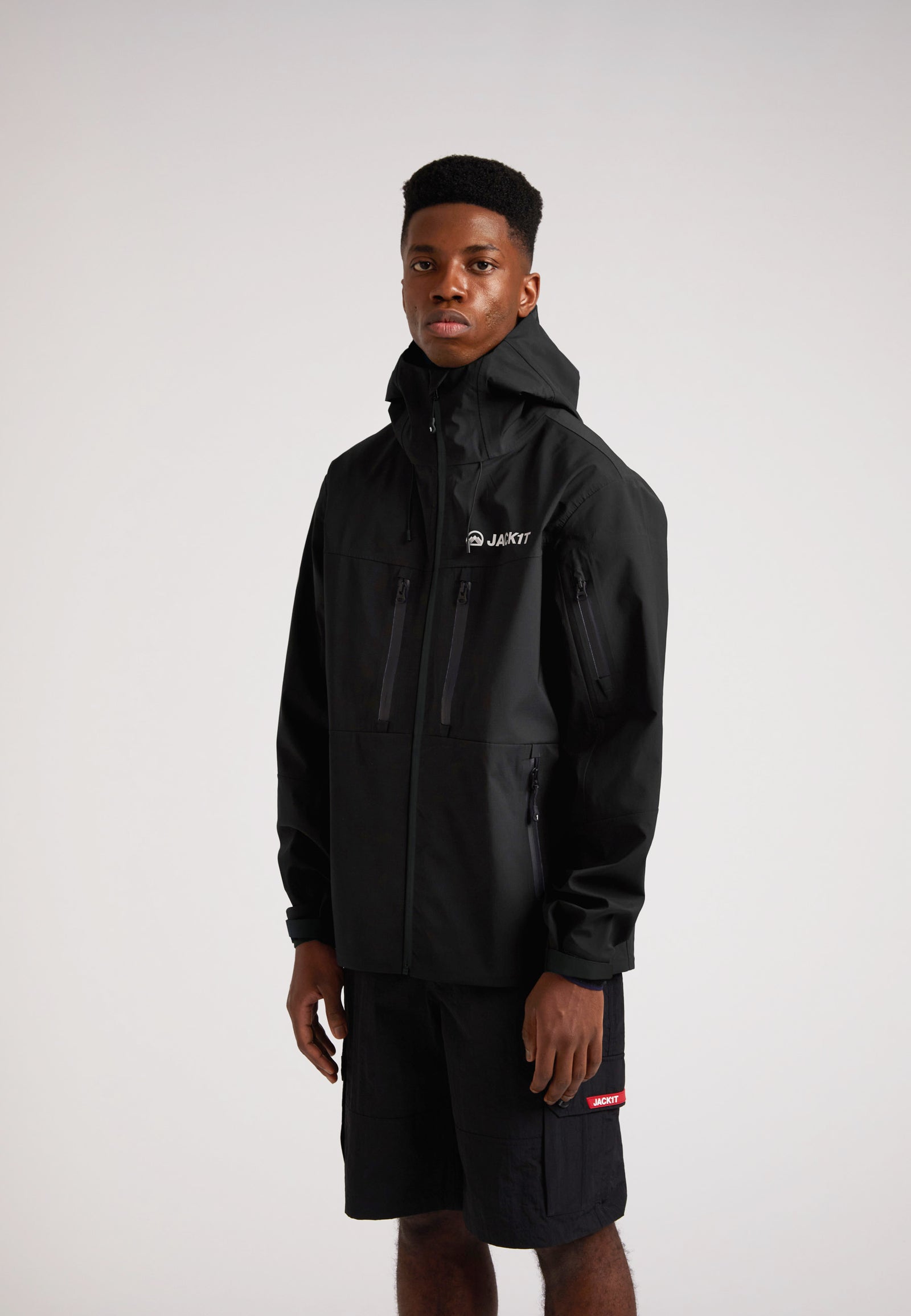 Black mens Lithium waterproof jacket worn by a model, showcasing its waterproof design and functionality.