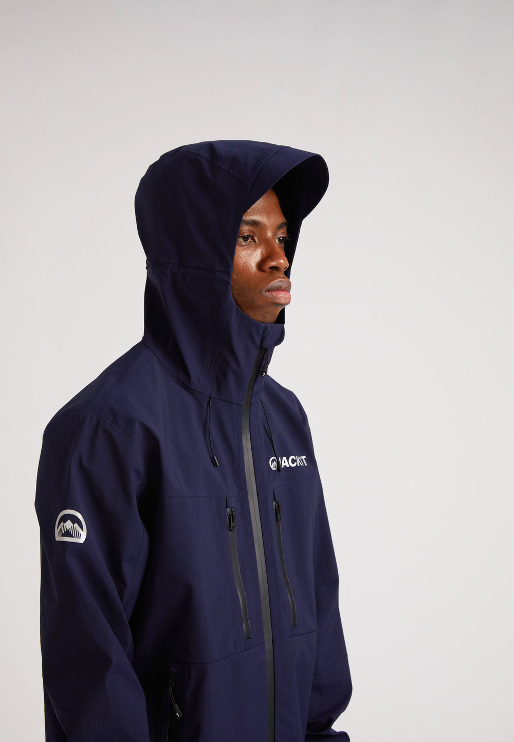 navy lithium waterproof mens jacket worn by a model with the hood up, showcasing its stylish design and functionality.