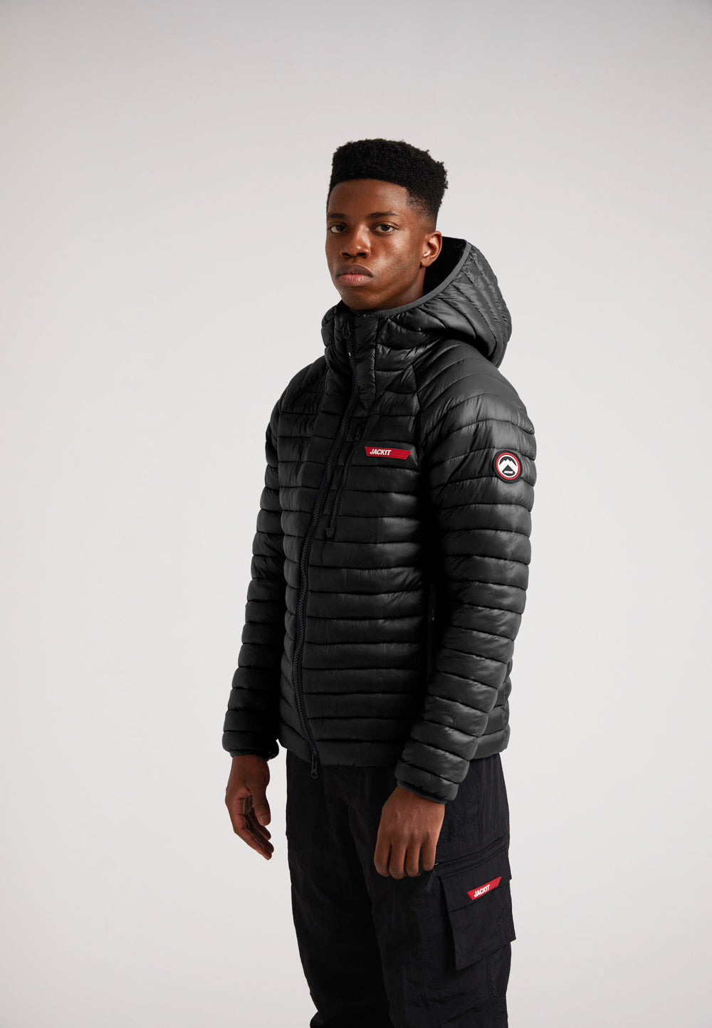 SATEL1TE Hooded Jacket 2.0 Black worn by a model, showcasing the stylish design and performance features.