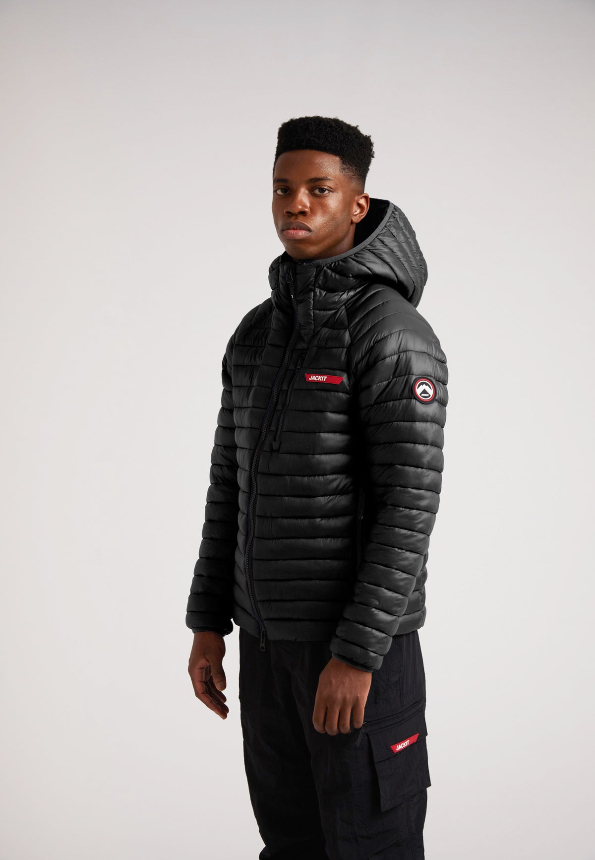 SATEL1TE Hooded Jacket 2.0 Black worn by a model, showcasing the stylish design and performance features.