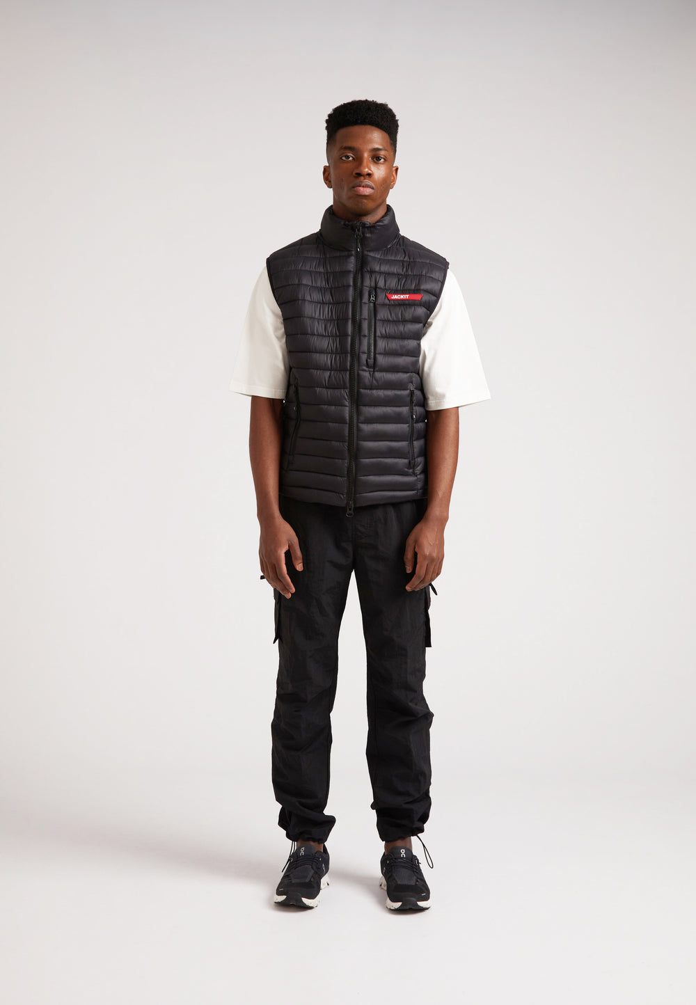 Model wearing SATEL1TE Lightweight Puffer Gilet 2.0 Black, showcasing its stylish and versatile design.