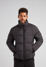Man wearing Cloud Lightweight Puffer Racer Jacket Black, a sleek and insulated winter jacket.