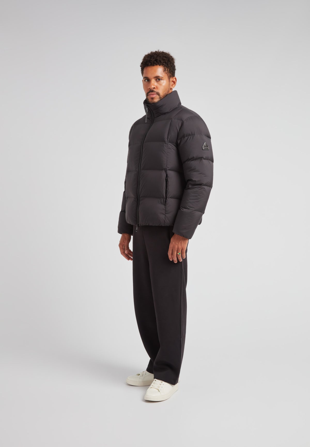 Model wearing the Cloud Lightweight Puffer Racer Jacket Black, showcasing a sleek design and stylish fit.