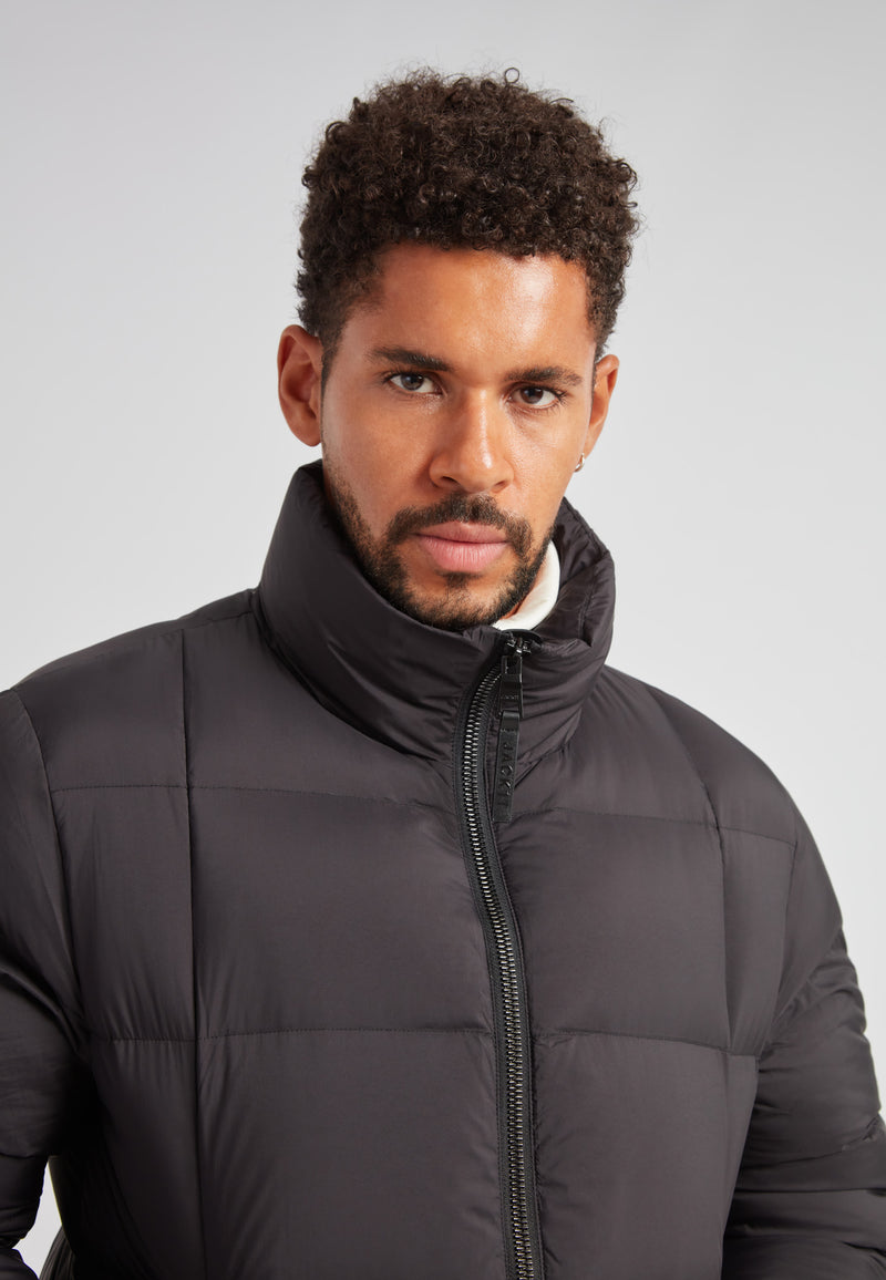 Cloud Lightweight Puffer Racer Jacket Black model showcasing its sleek design and warmth features.