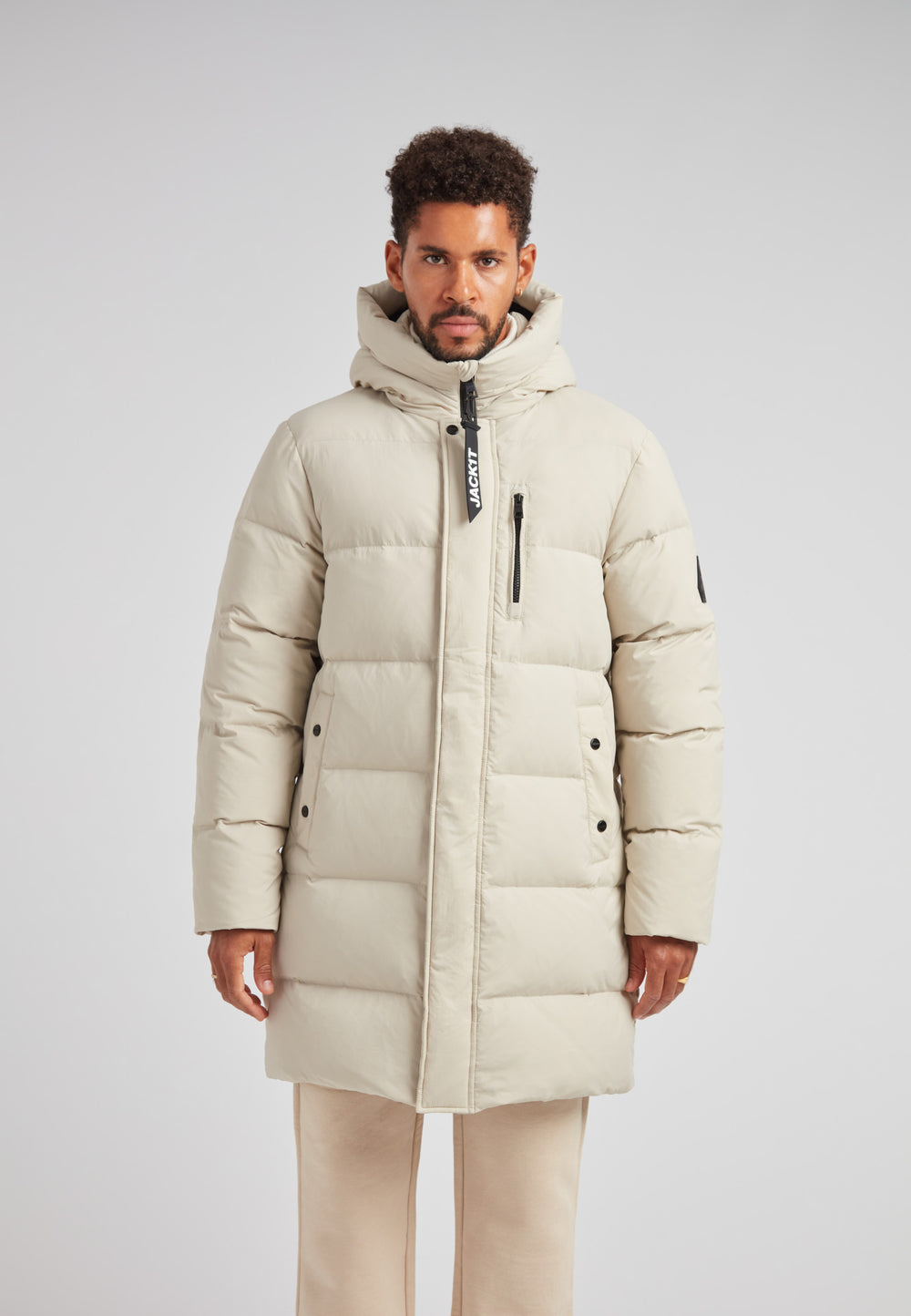 Stone Nomad Down Parka Coat for Men worn by a model in a light-colored setting.