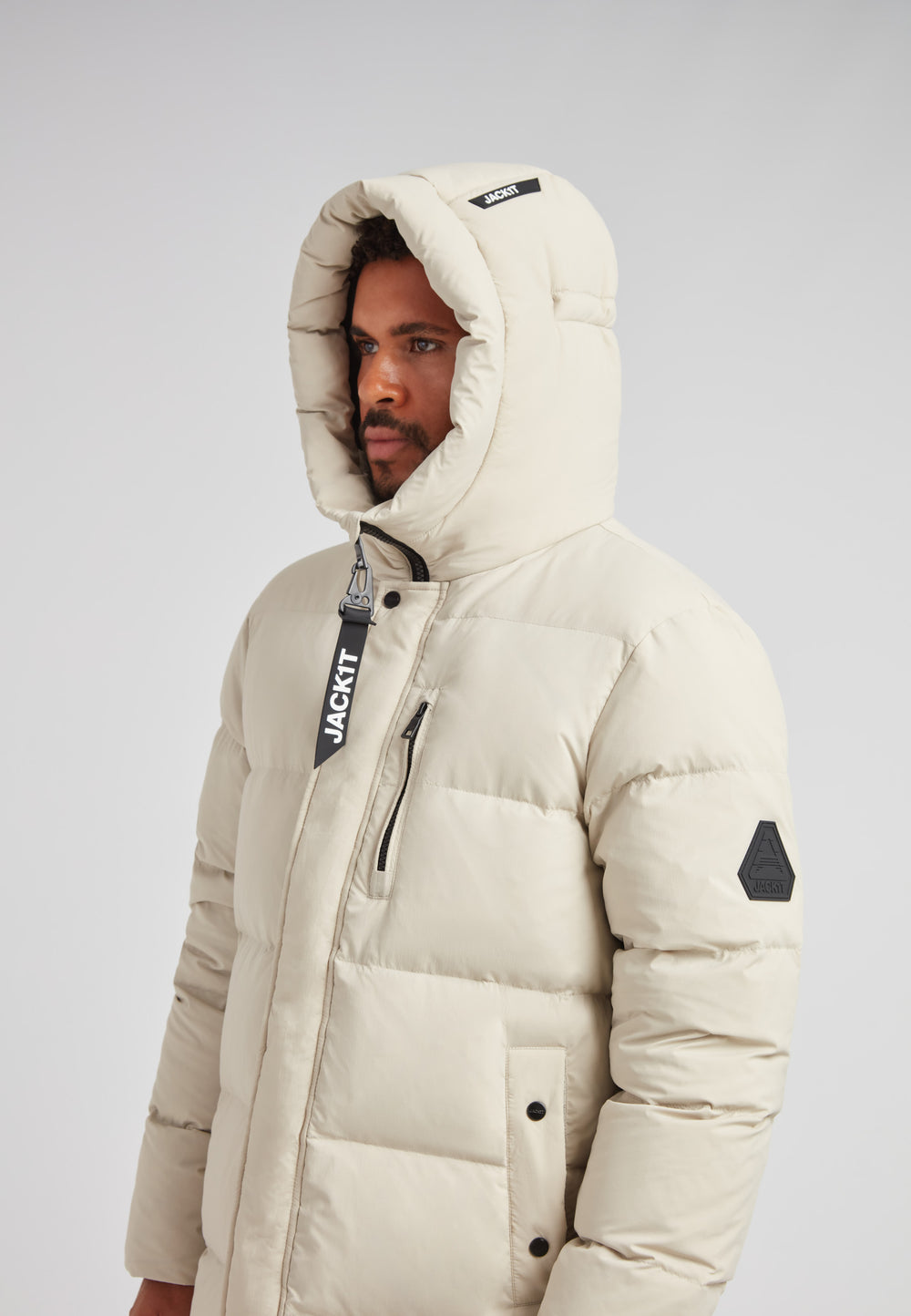Stone Nomad Down Parka Coat for Men worn by model, showcasing hood and warm design.