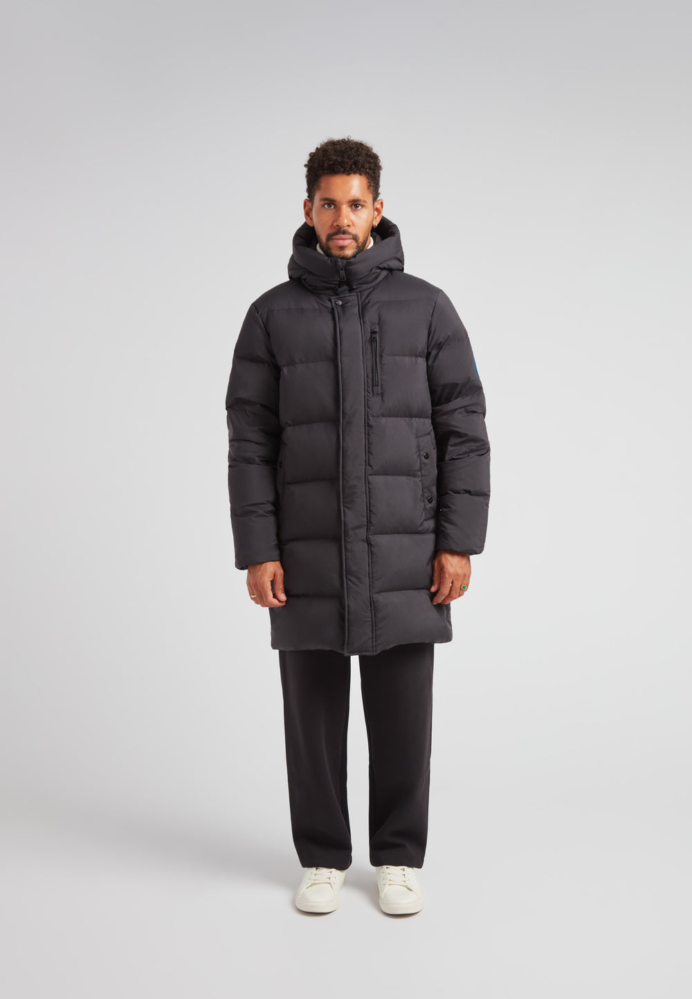 Down Parka Coat for Men in Black with padded insulation and hood, designed for winter protection.