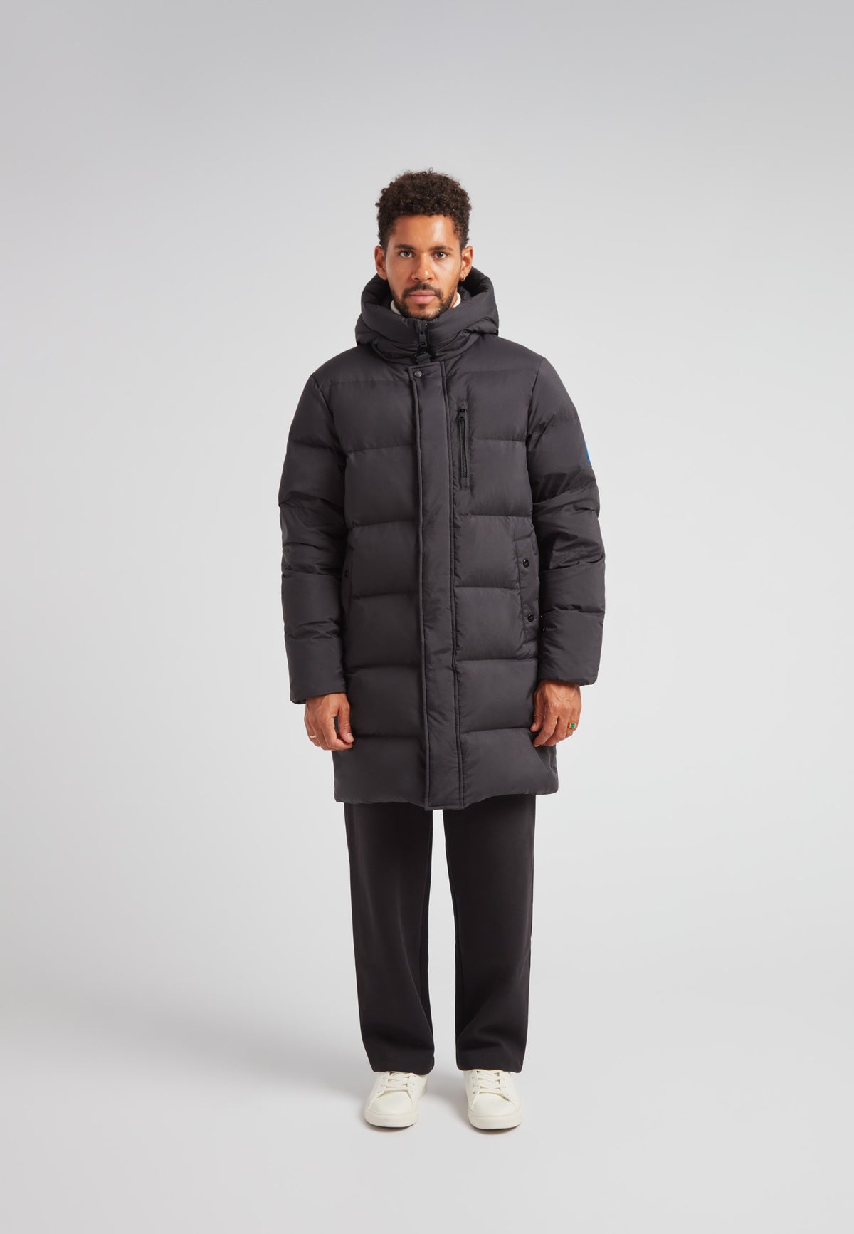 Down Parka Coat for Men in Black with padded insulation and hood, designed for winter protection.