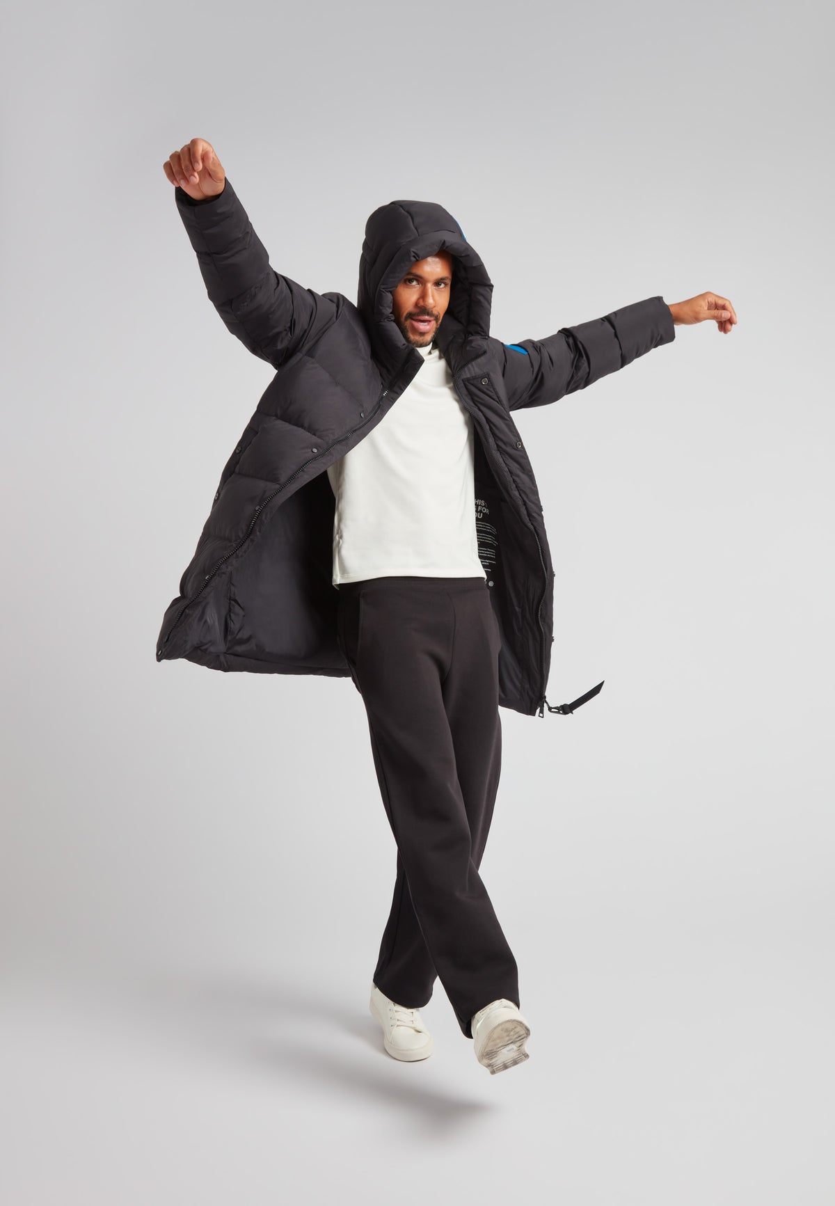 Man wearing a Down Parka Coat for Men in Black, showcasing its warmth and stylish design.
