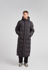 Mens Extra Long Puffer Coat in Black worn by a model, showcasing its stylish and warm design.