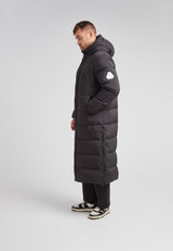 Mens Extra Long Puffer Coat in Black shown side view, highlighting its ankle-length and stylish silhouette.