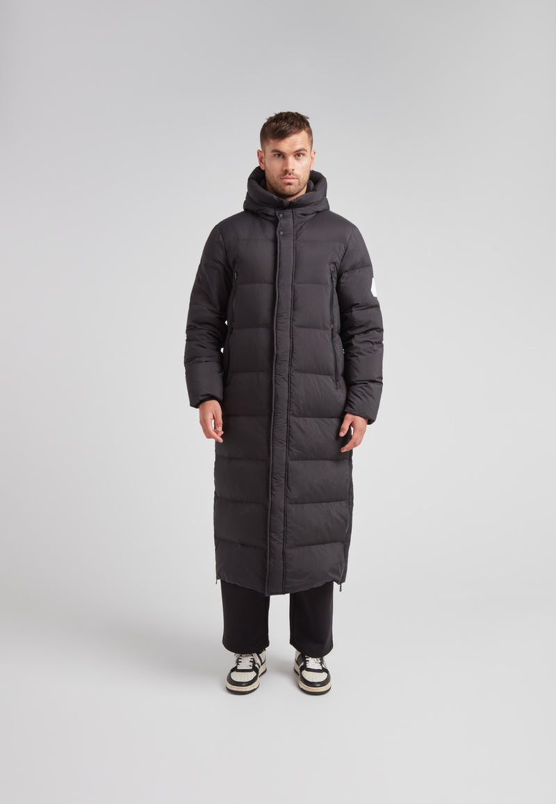 Mens Extra Long Puffer Coat in Black worn by a model, showcasing a sleek and warm winter design.