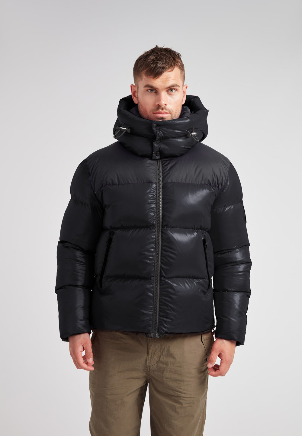 Expedition Parka Puffer Men Black worn by a model, showcasing its boxy silhouette and oversized hood.