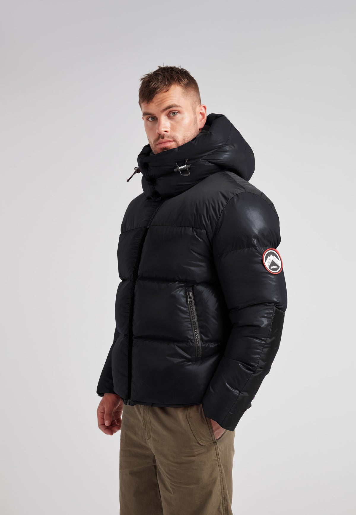 Man wearing Expedition Parka Puffer Men Black jacket with oversized hood and boxy silhouette.