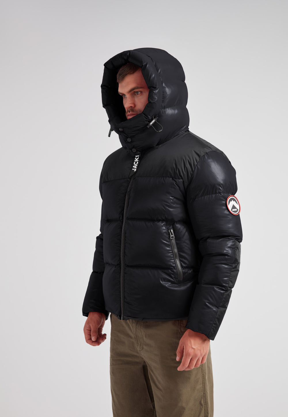Expedition Parka Puffer Men Black worn by a man with oversized hood and boxy silhouette in a stylish pose.