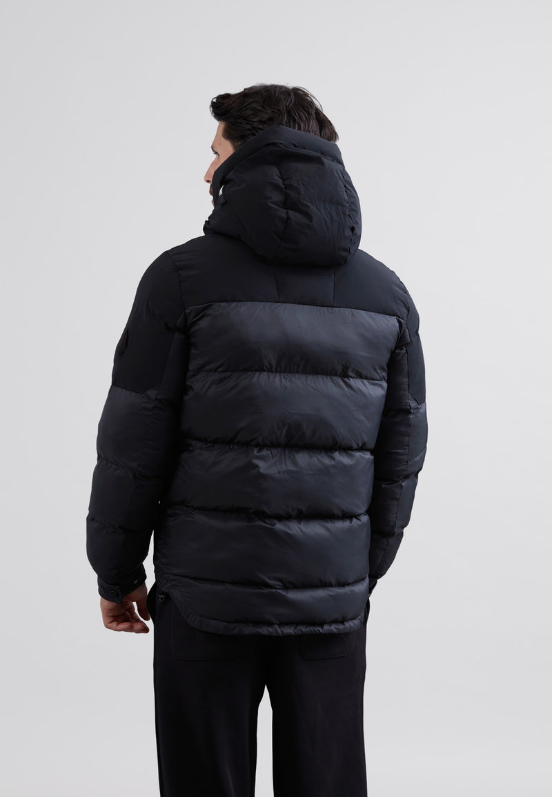 Luna Lightweight Mens Puffer Jacket Black worn by a man from behind, showcasing its sleek design and hood.
