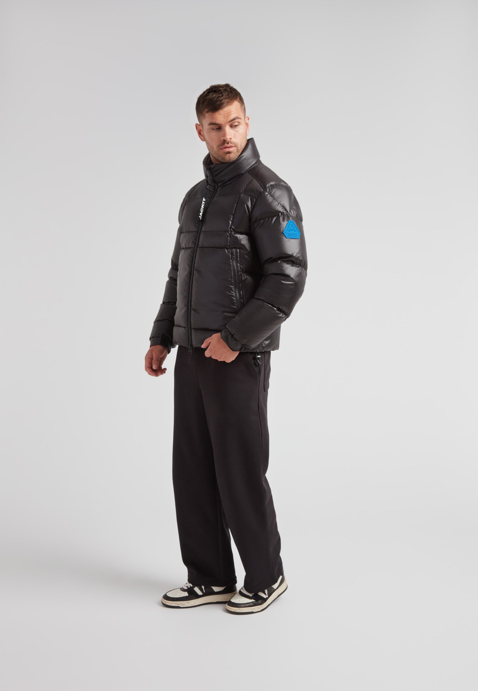 EZ Boxed Funnel Puffer Jacket Lux Black worn by a model in a stylish pose on a neutral background.