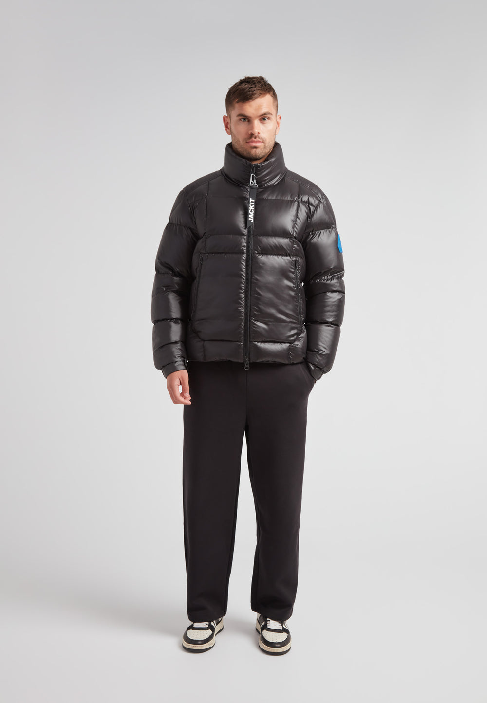 Man wearing EZ Boxed Funnel Puffer Jacket Lux Black, showcasing a sleek winter-ready style.