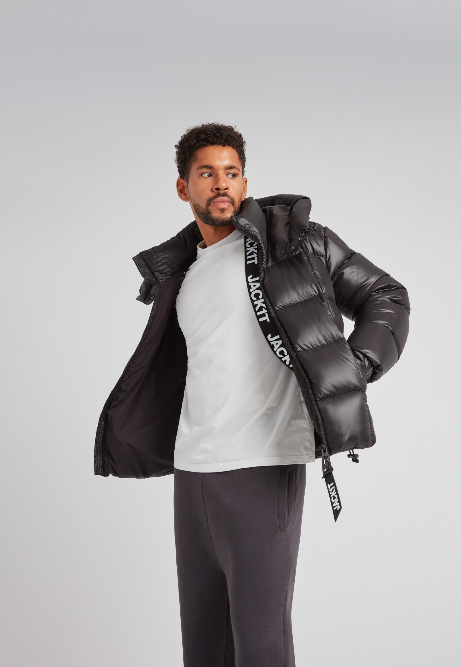 Man wearing the EZ Boxed Puffer Racer Jacket Lux Black, showcasing its stylish and warm design.