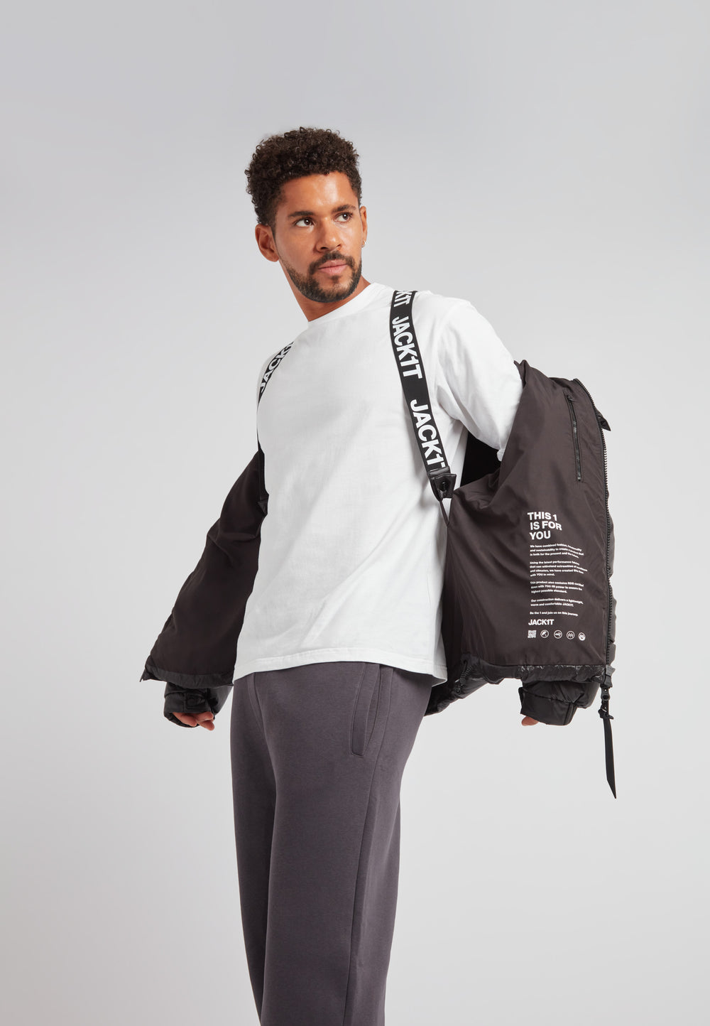 Man wearing EZ Boxed Puffer Racer Jacket Lux Black, showcasing urban athletic style and comfort.