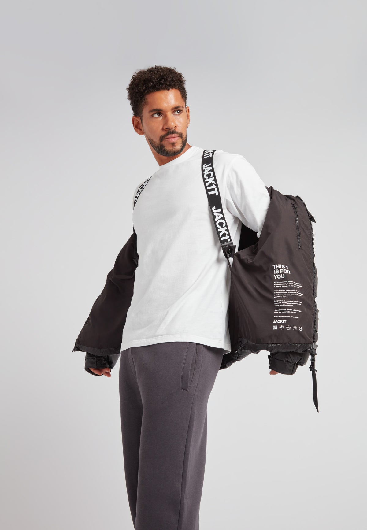 Man wearing EZ Boxed Puffer Racer Jacket Lux Black, showcasing urban athletic style and comfort.