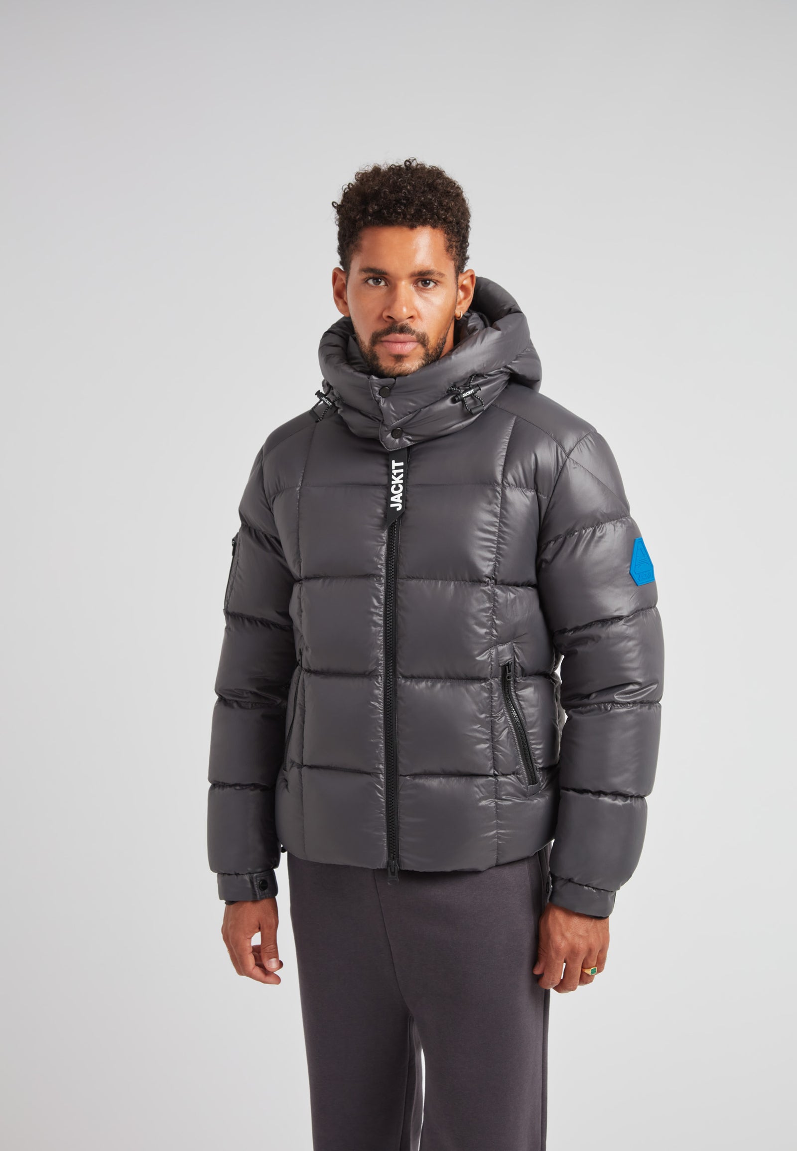 EZ Boxed Puffer Racer Jacket Lux Graphite worn by a man, featuring a hood and sleek design, perfect for winter.