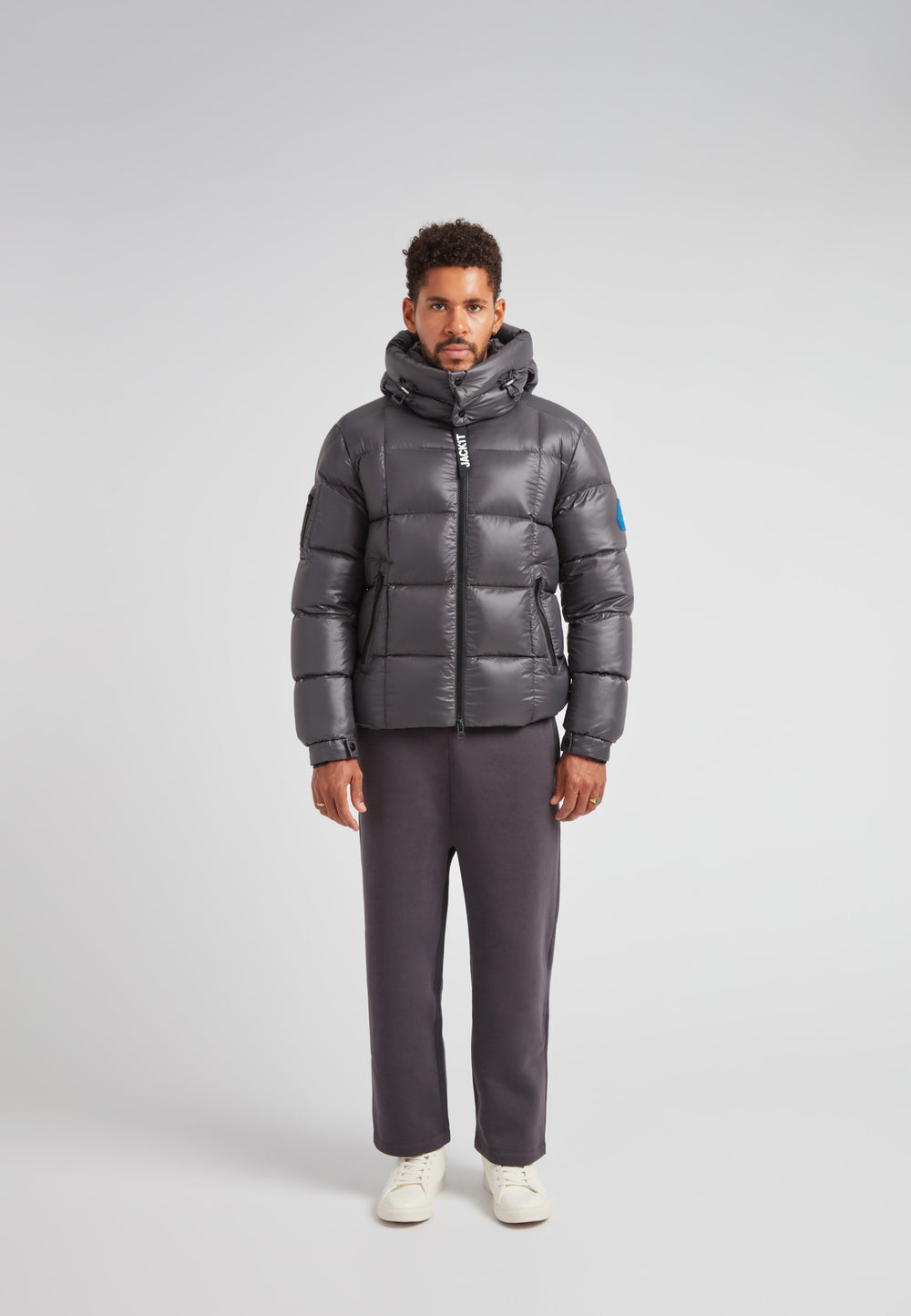 EZ Boxed Puffer Racer Jacket Lux Graphite worn by a model, showcasing its sleek winter design and funnel neck.