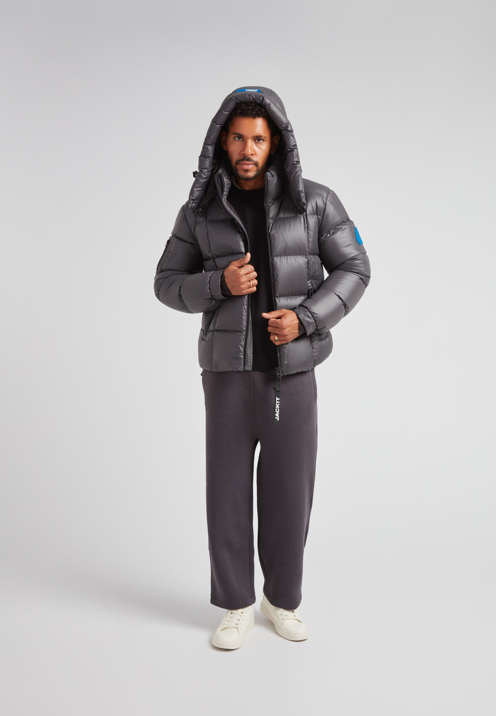 Man wearing EZ Boxed Puffer Racer Jacket Lux Graphite, showcasing winter style and functionality.