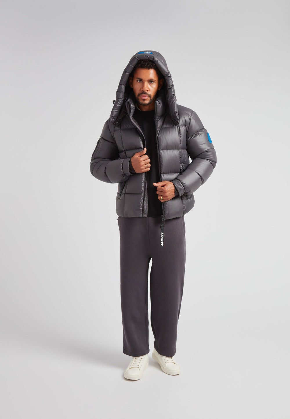 Man wearing EZ Boxed Puffer Racer Jacket Lux Graphite, showcasing winter style and functionality.