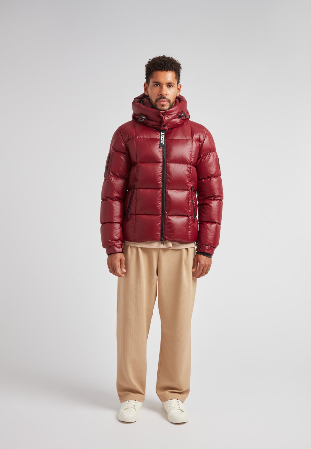EZ Boxed Puffer Racer Jacket Lux Red worn by a model standing against a light background in a stylish urban setting.