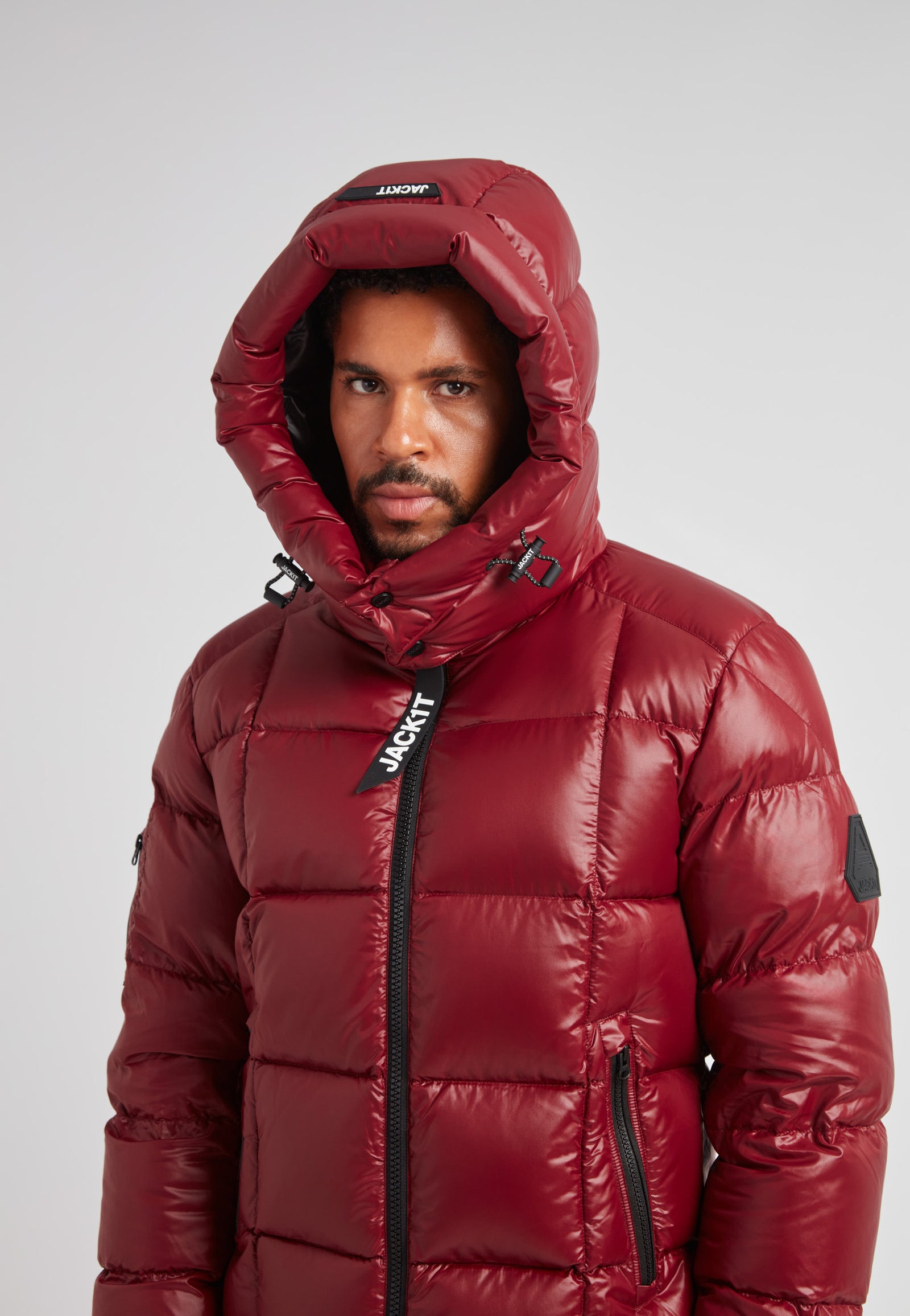 EZ Boxed Puffer Racer Jacket Lux Red worn by a model, showcasing its stylish warm design and insulated features.