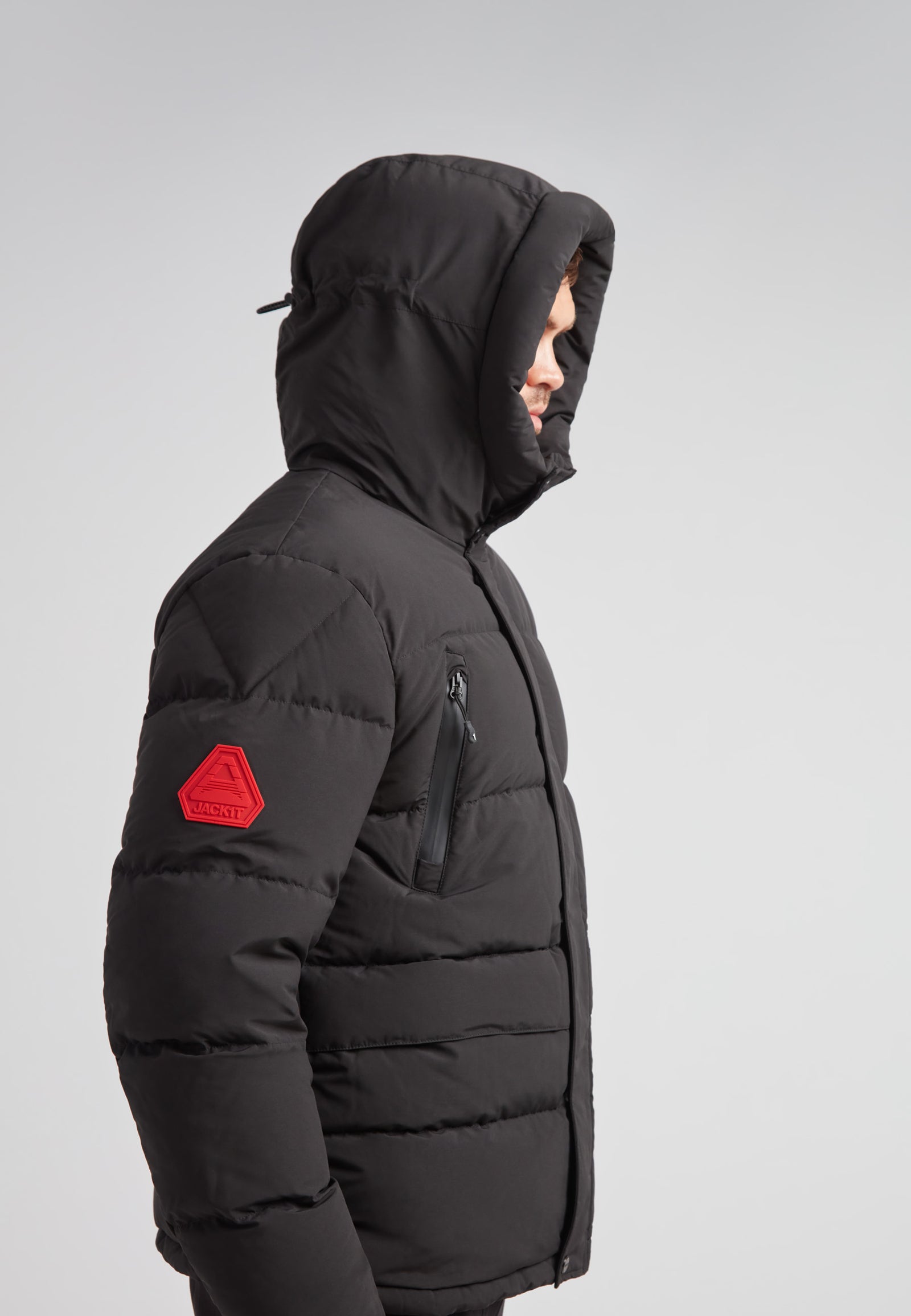 EZ Frontier Prime Down Puffer Jacket Matt Black side view with hooded design and red patch detail