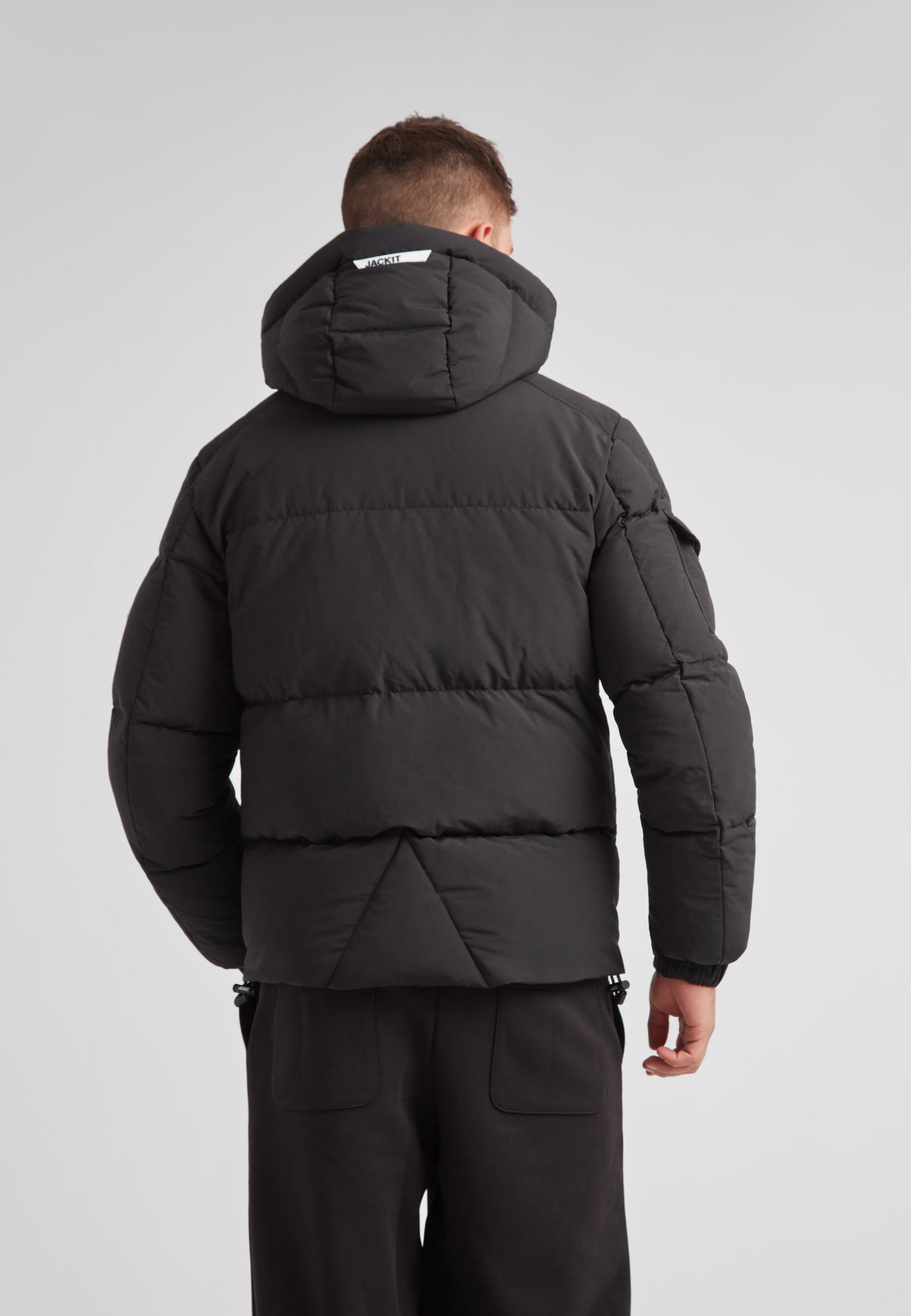 Back view of the EZ Water Puffer Racer Jacket Matt Black showcasing its stylish puffer design and detachable hood.