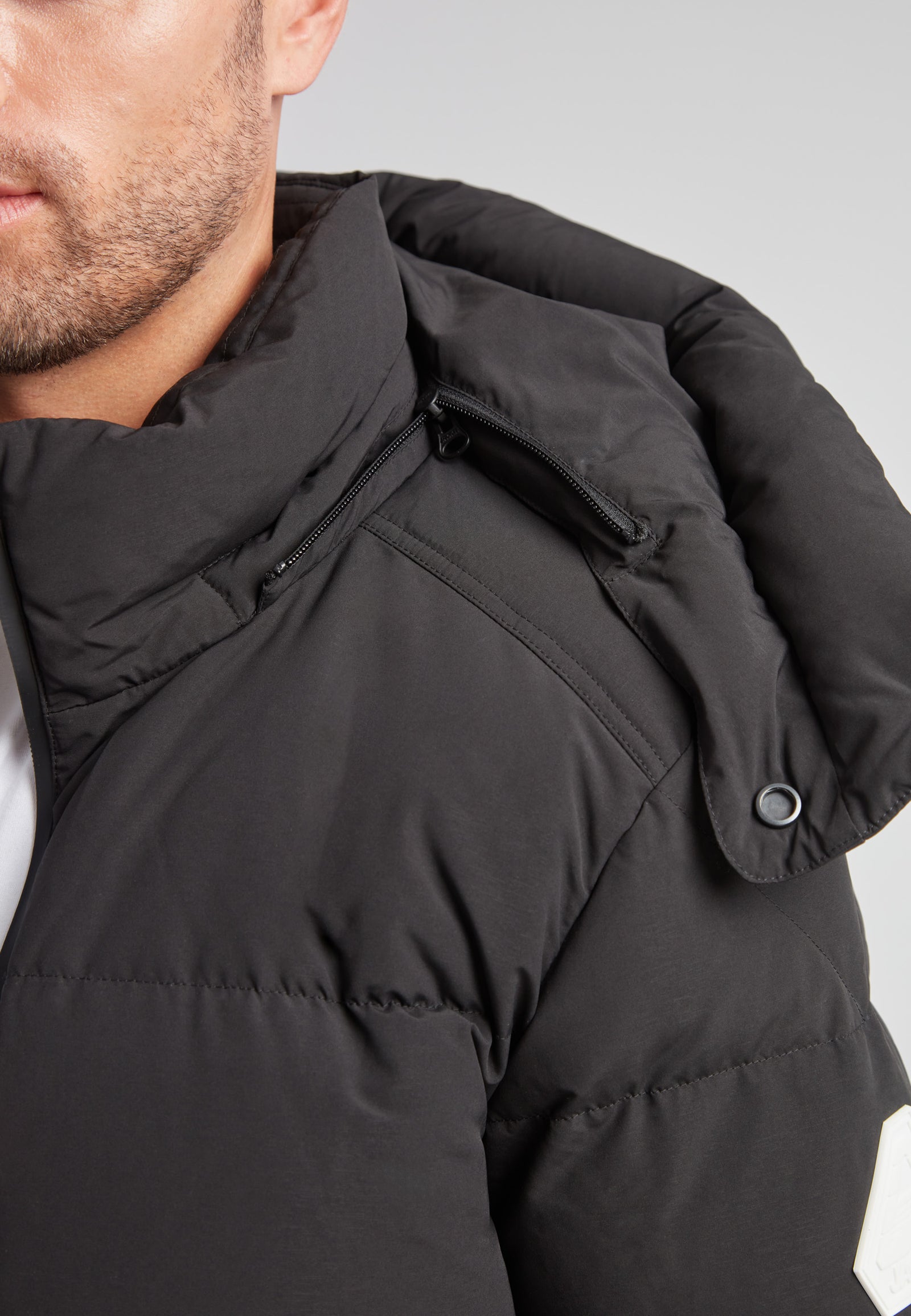 Close-up of EZ Water Puffer Racer Jacket Matt Black showcasing the collar and zipper details.