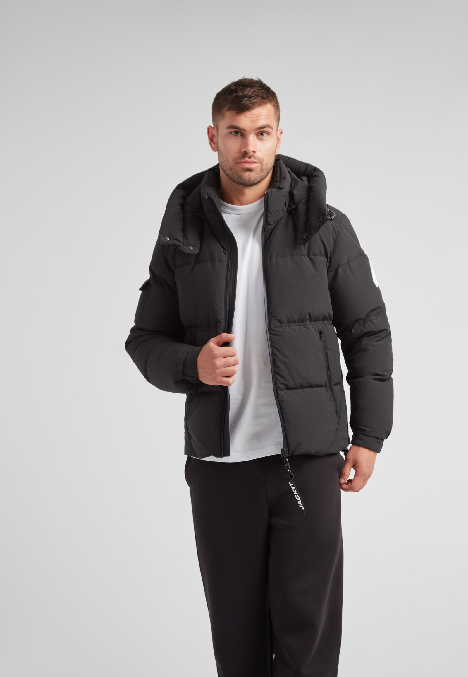 Model wearing EZ Water Puffer Racer Jacket Matt Black, showcasing modern design and functionality.