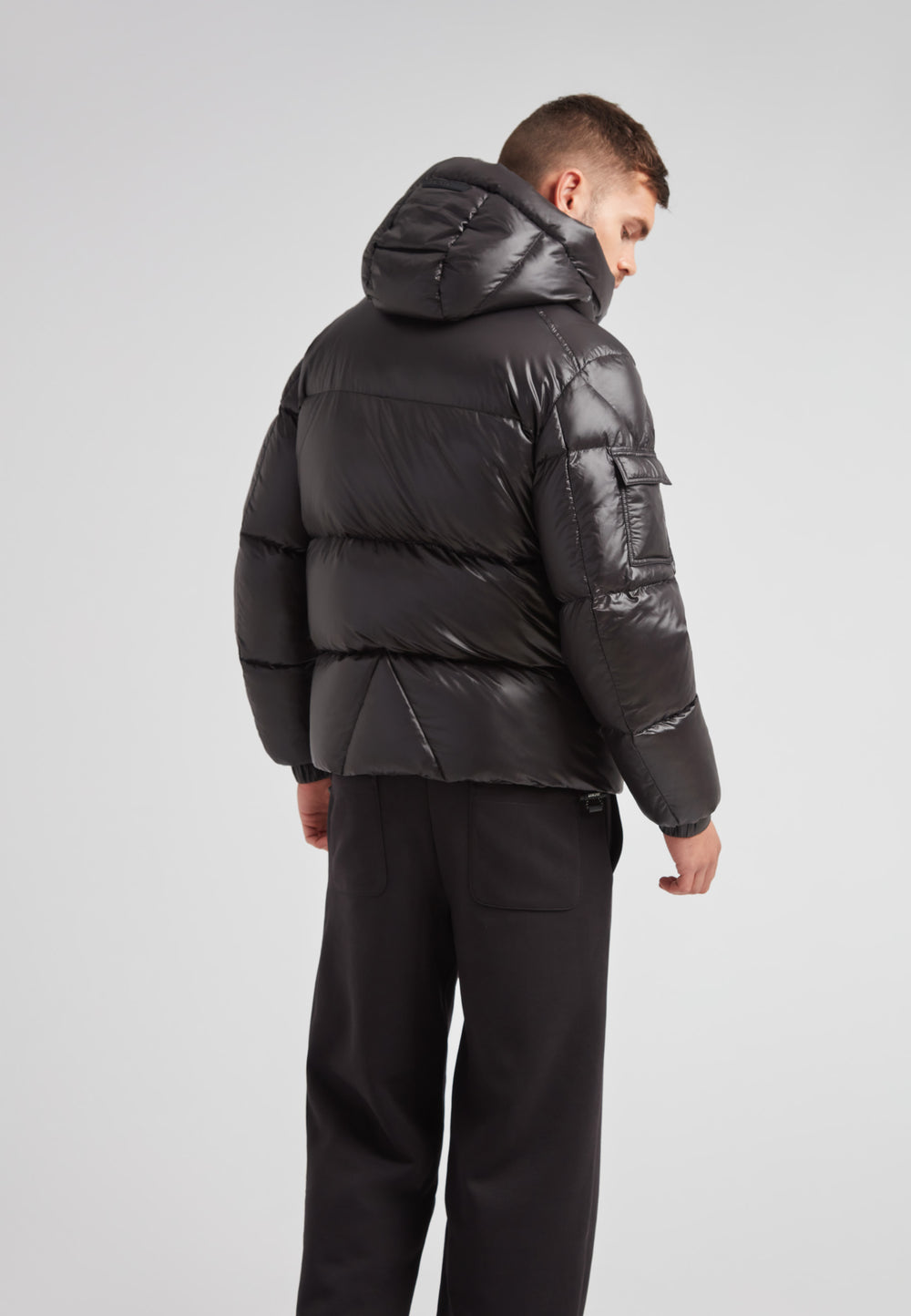 Back view of the EZ Water Puffer Racer Jacket Lux Black showcasing its sleek design and performance features.