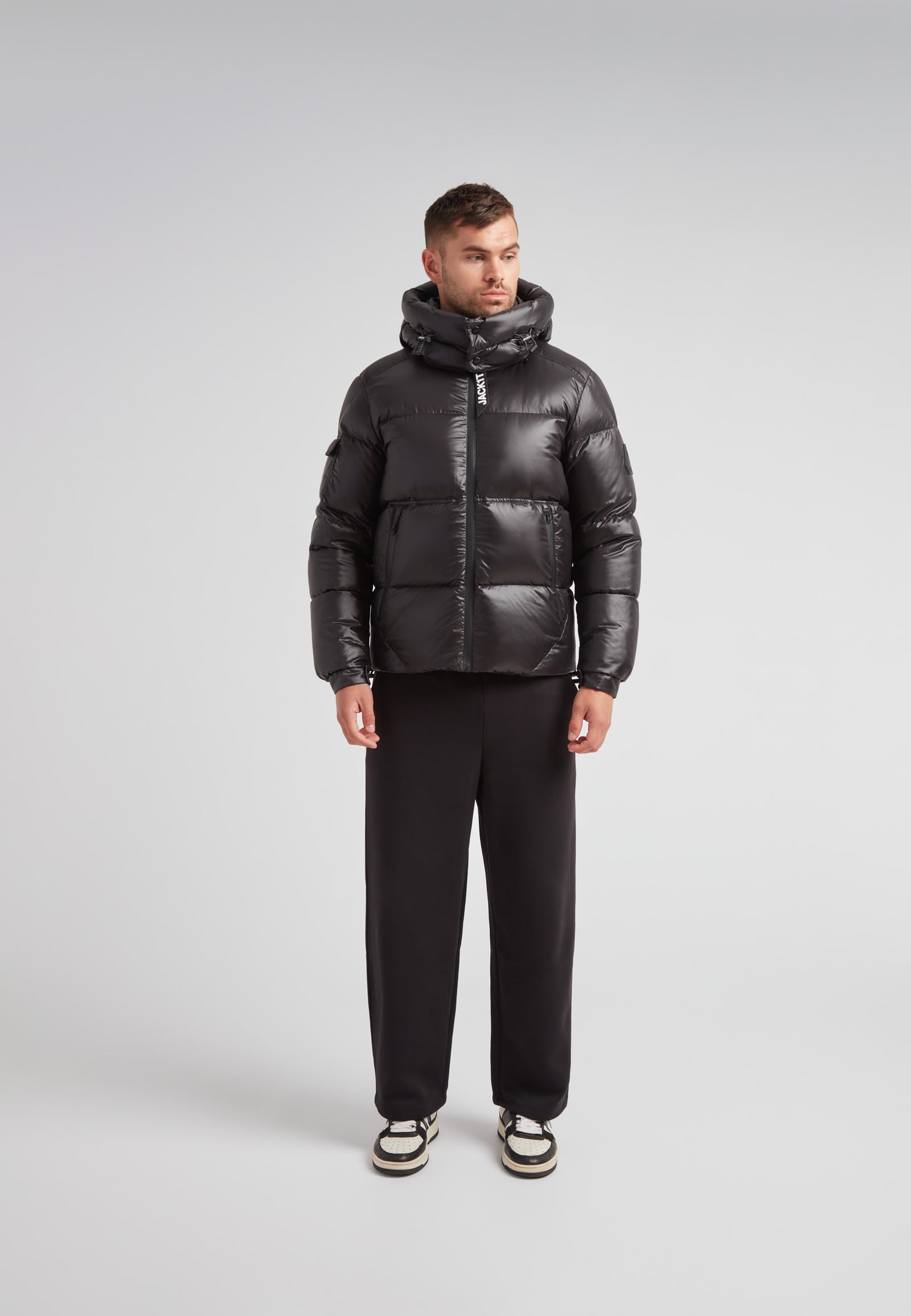 Model wearing the EZ Water Puffer Racer Jacket Lux Black with a stylish puffer design and urban look.