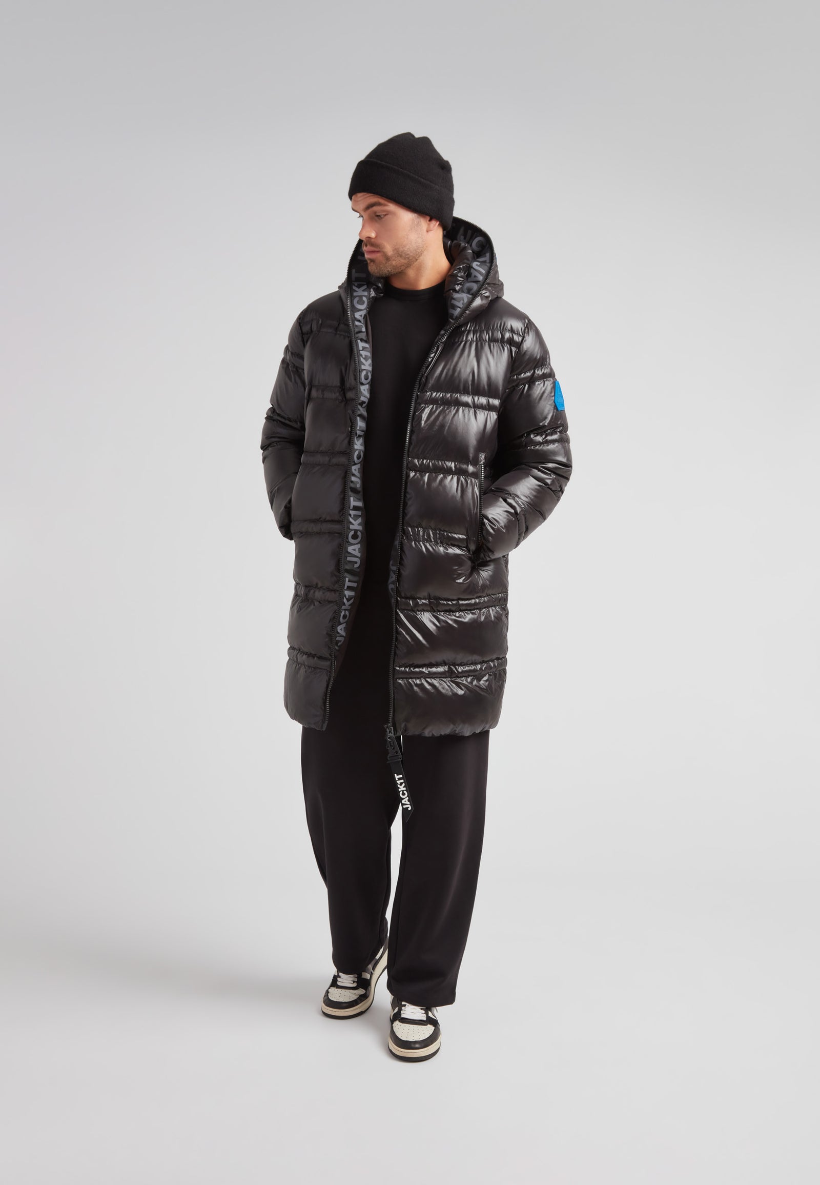 R4D Tramline Puffer Coat Lux Black displayed by a male model, showcasing its sleek design and insulation features.
