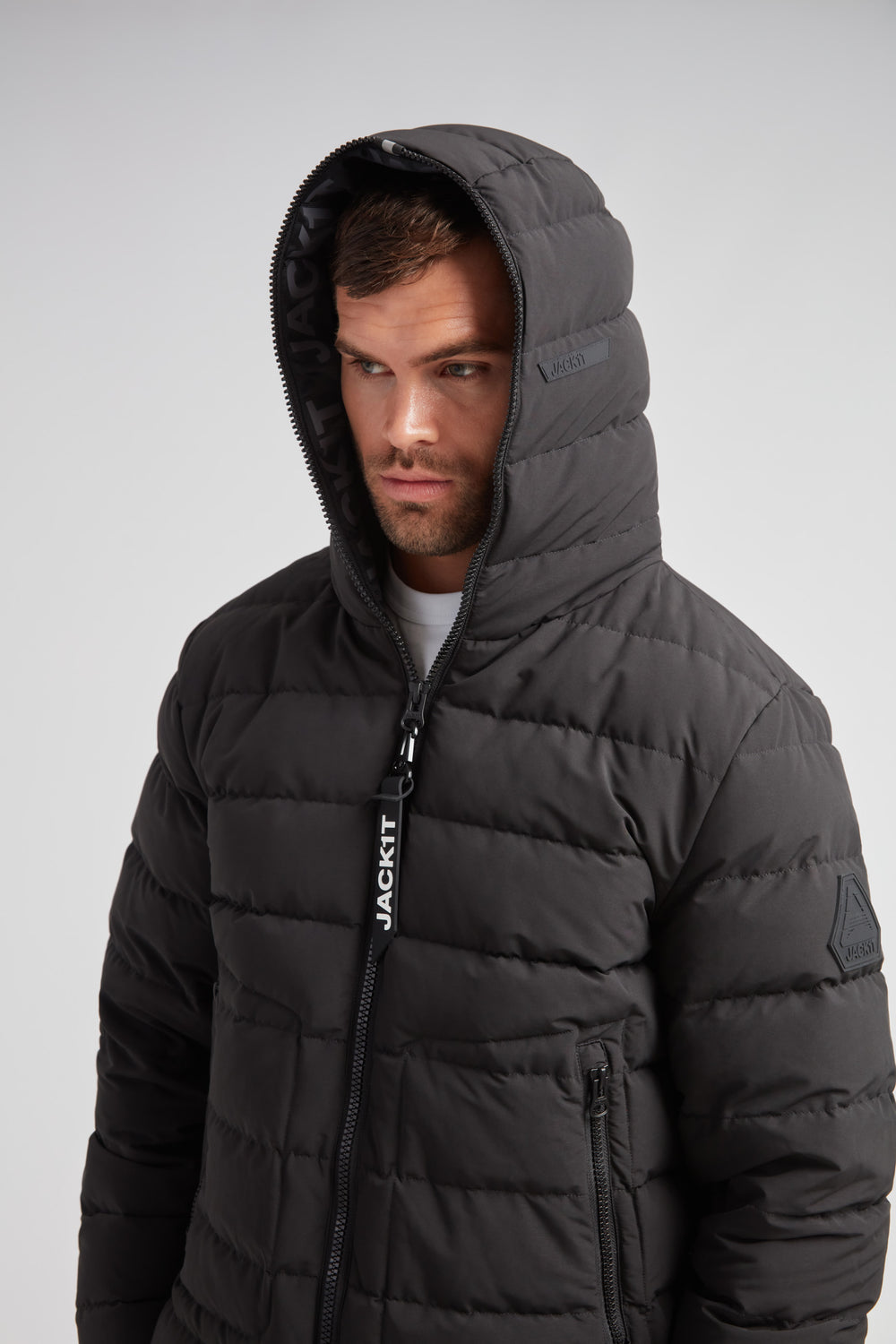 R4D Tramline Puffer Racer Jacket Matt Black worn by model with hood up, showcasing stylish winter design.