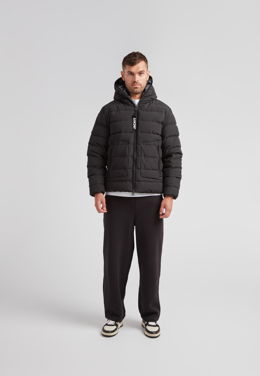 R4D Tramline Puffer Racer Jacket Matt Black worn by a man, showcasing modern winter fashion.