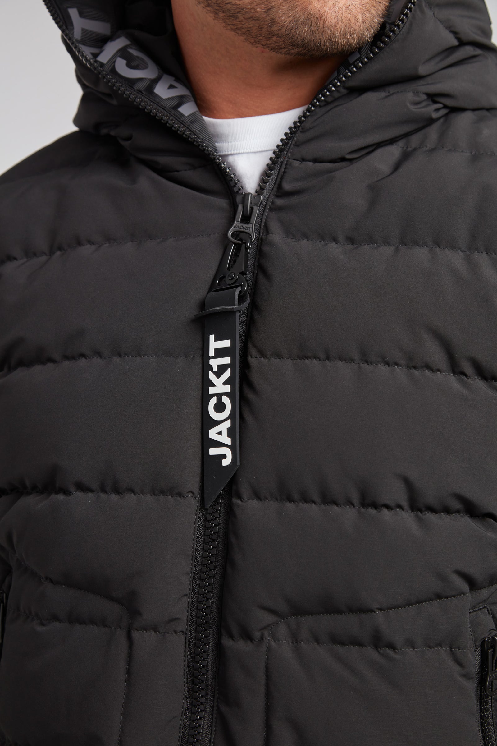 R4D Tramline Puffer Racer Jacket Matt Black close-up showing zip and hood details from JACK1T.