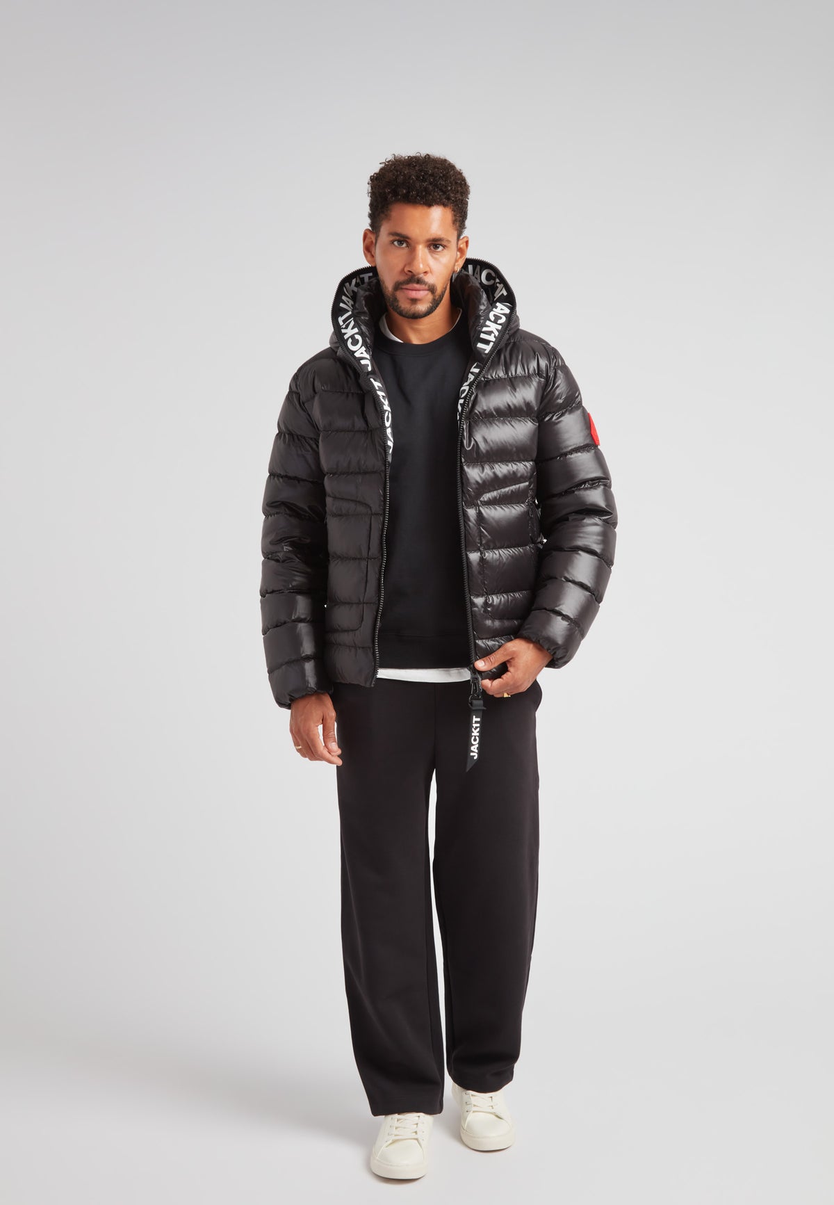 R4D Tramline Puffer Racer Jacket Lux Black worn by a model, showcasing its sleek design and technical features.