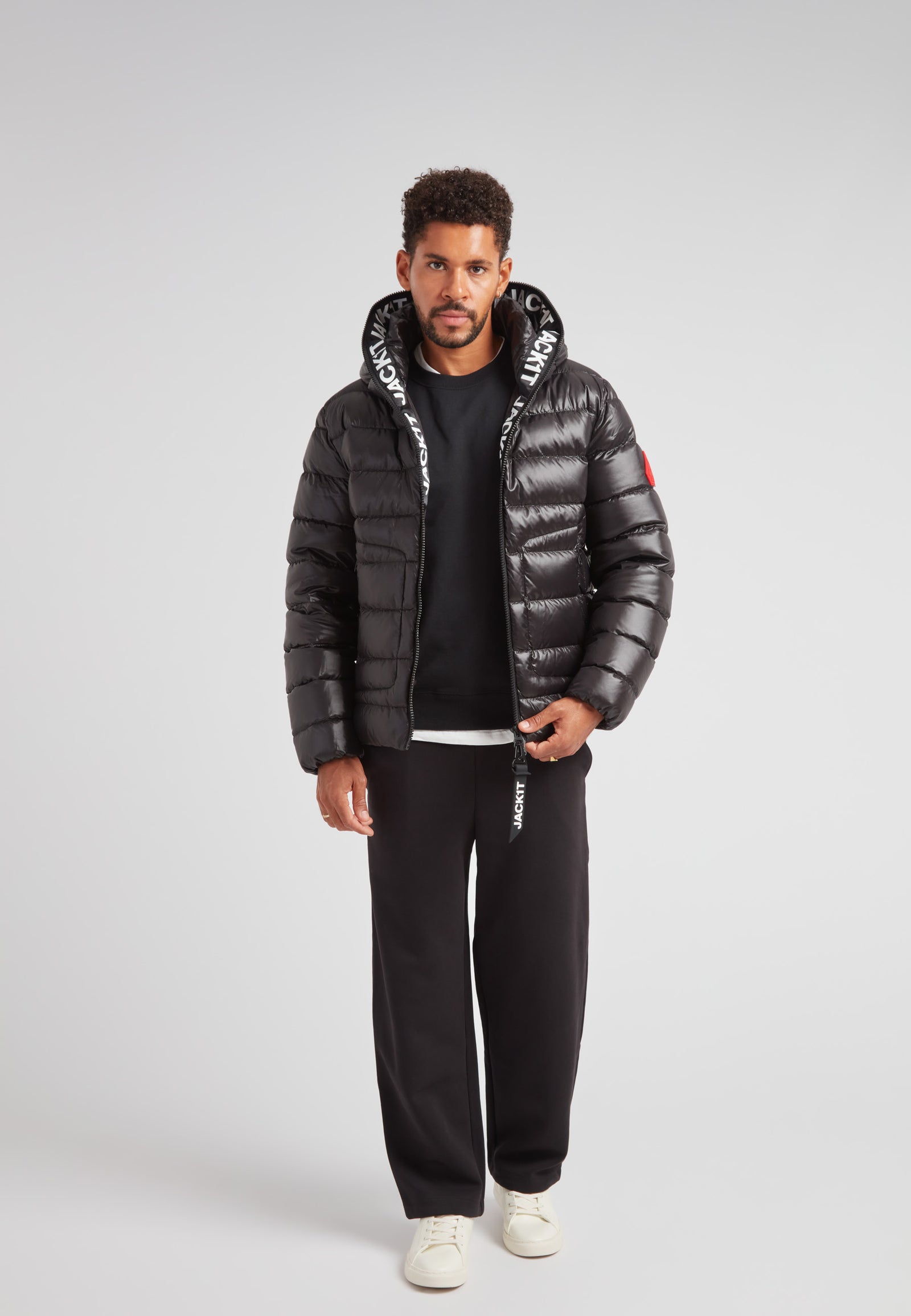 R4D Tramline Puffer Racer Jacket Lux Black worn by a model, showcasing its sleek design and technical features.