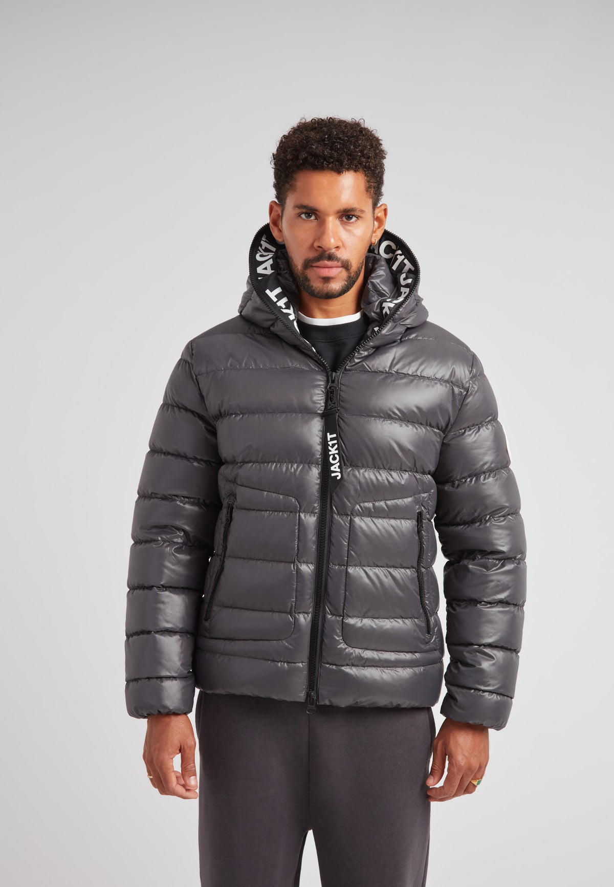 R4D Tramline Puffer Racer Jacket Lux Graphite worn by a model showcasing its sleek design and hood.